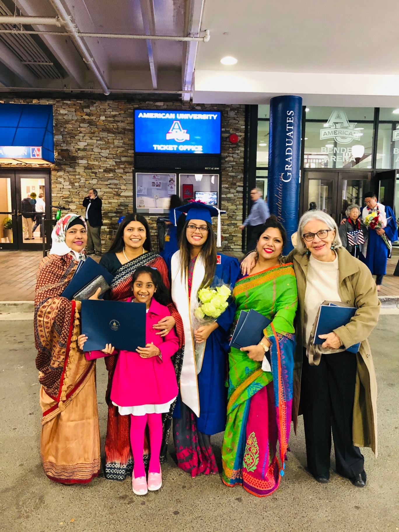 A Sisters Circle mentee at her graduation with mentors and family