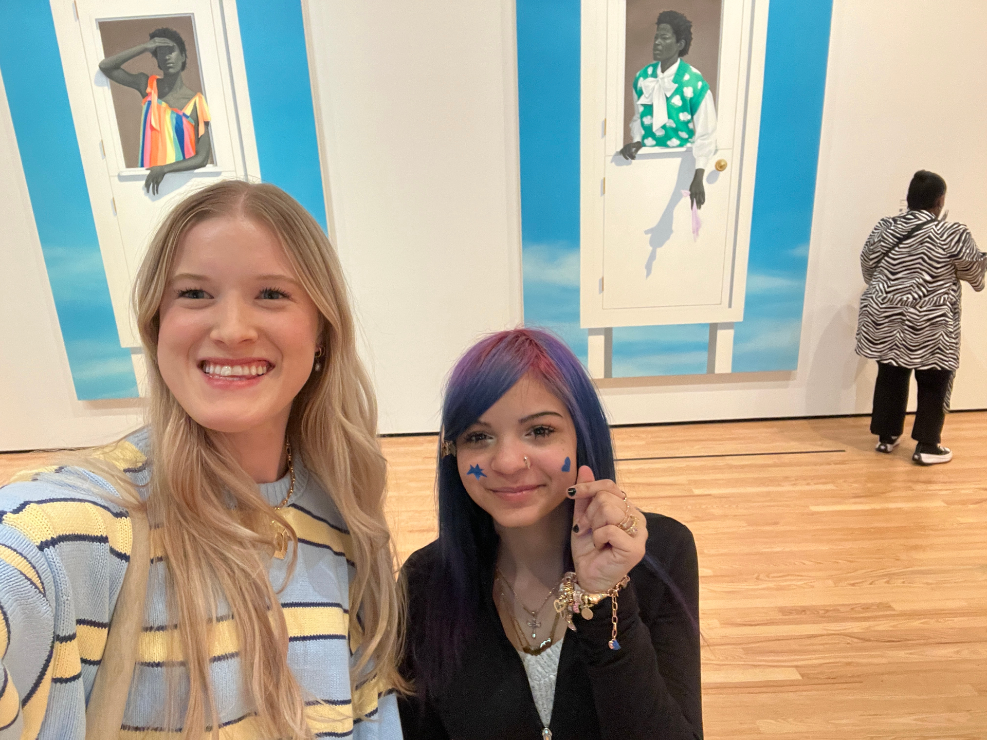 A mentor and mentee taking a selfie in an art museum